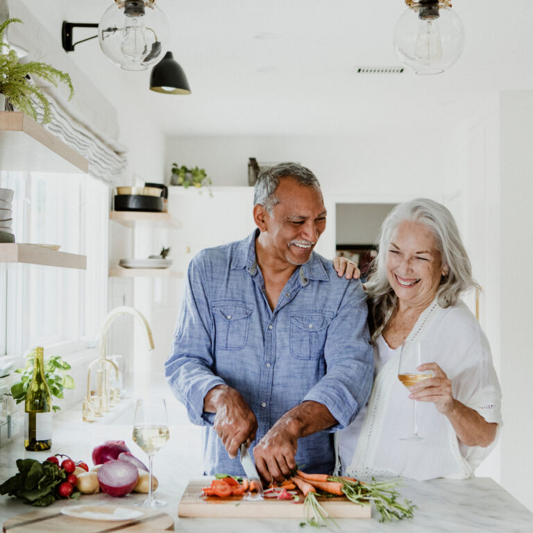 Elderly couple cooking in a kitchen